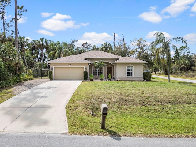 view of front of house with stucco siding, concrete driveway, a front yard, fence, and a garage