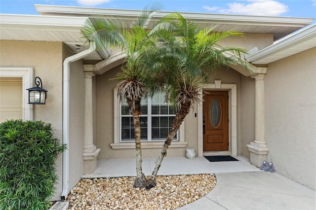 entrance to property featuring stucco siding