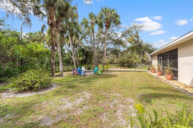 view of yard with a fire pit and a fenced backyard