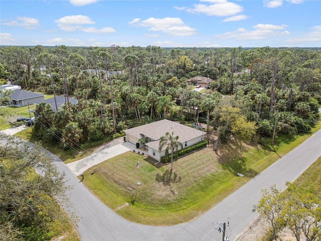 bird's eye view with a wooded view