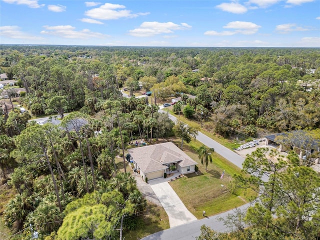 birds eye view of property featuring a wooded view