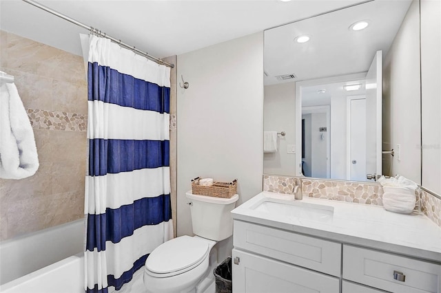 full bathroom featuring toilet, visible vents, vanity, backsplash, and shower / bath combo