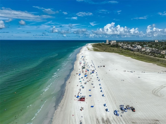 birds eye view of property featuring a beach view and a water view