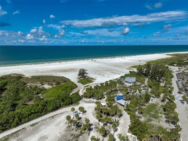 drone / aerial view featuring a beach view and a water view