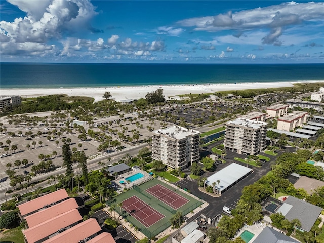 birds eye view of property featuring a water view and a beach view