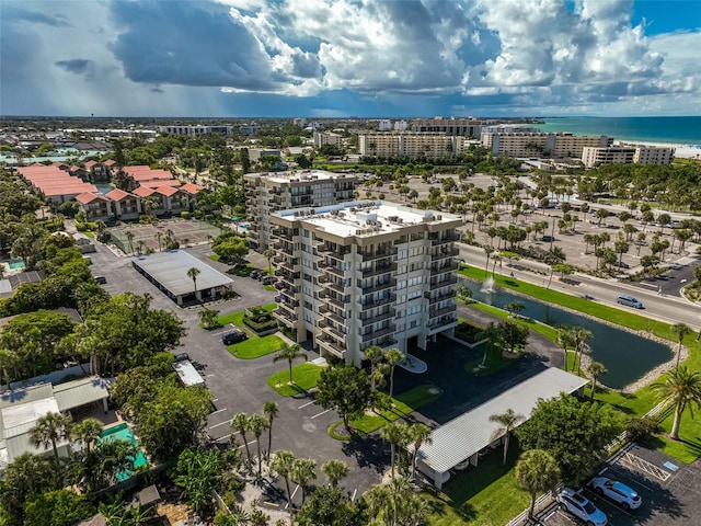 birds eye view of property featuring a view of city and a water view