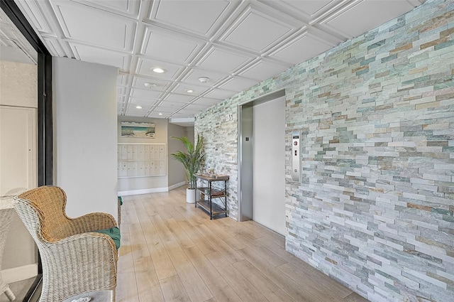 hall featuring elevator, an ornate ceiling, mail area, light wood-type flooring, and recessed lighting