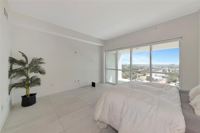 bedroom with light tile patterned floors and visible vents