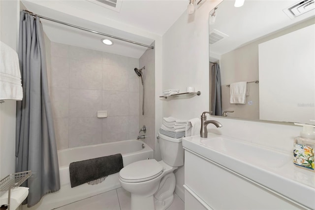 bathroom featuring visible vents, vanity, shower / bath combo with shower curtain, and toilet