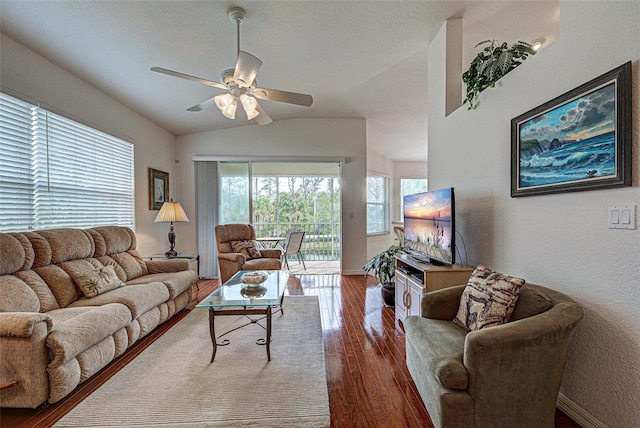 living room featuring a ceiling fan, lofted ceiling, baseboards, and wood finished floors