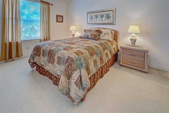 carpeted bedroom with baseboards