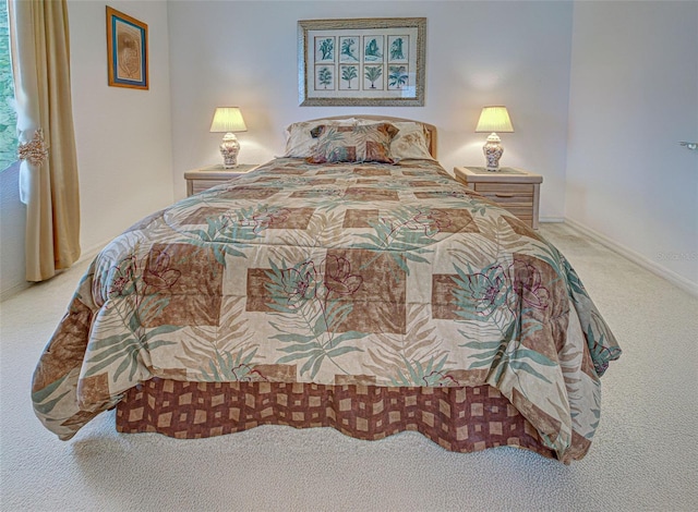 carpeted bedroom with baseboards