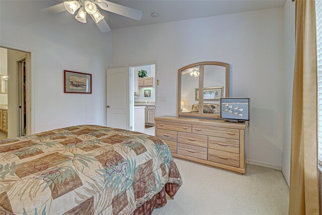 bedroom with light carpet, ceiling fan, and ensuite bathroom