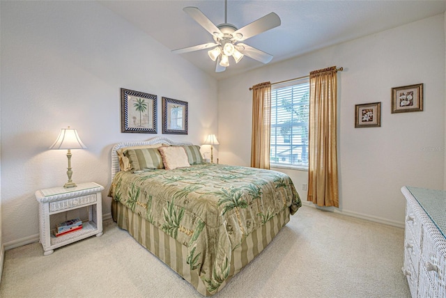 bedroom featuring a ceiling fan, light carpet, vaulted ceiling, and baseboards