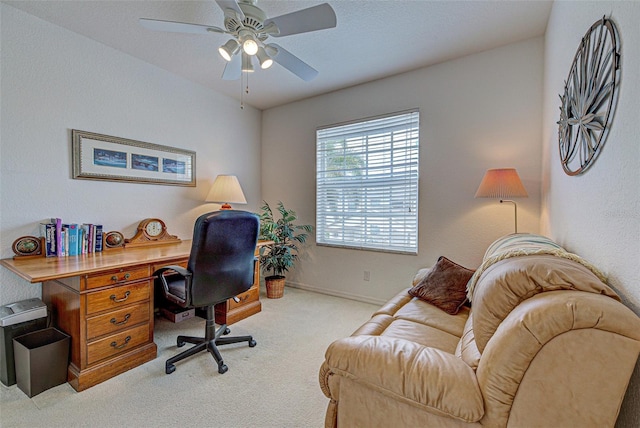 office space with baseboards, a ceiling fan, and carpet flooring