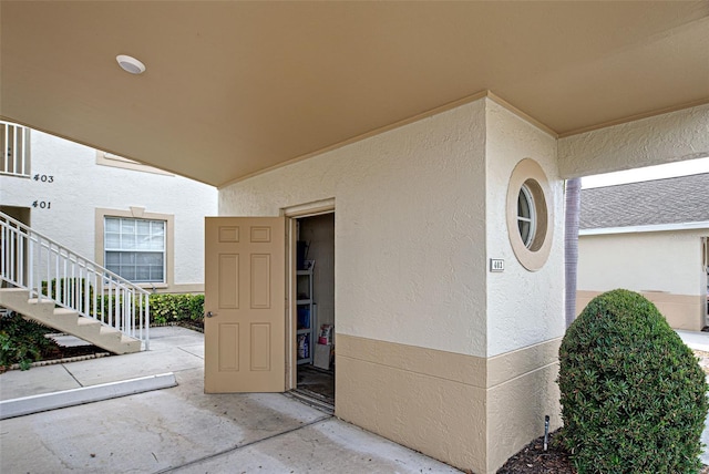 property entrance with stucco siding