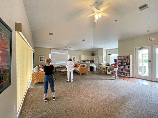 carpeted living area featuring ceiling fan, visible vents, and french doors