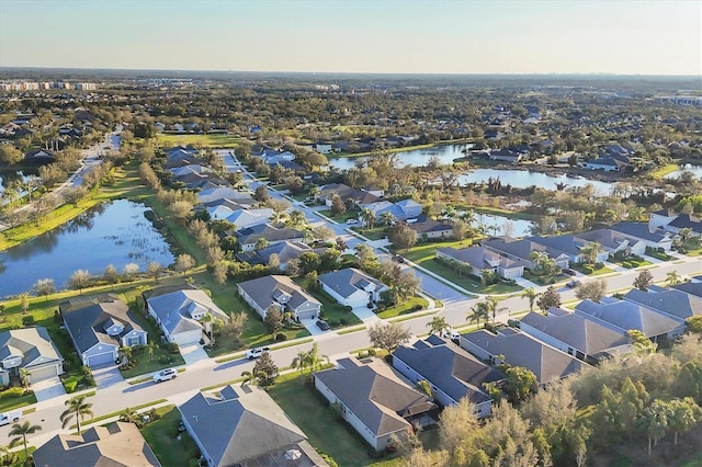 birds eye view of property featuring a water view and a residential view