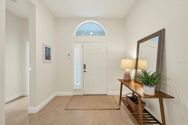 foyer featuring baseboards and light tile patterned flooring