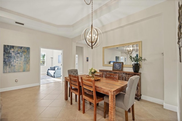 dining space featuring light tile patterned flooring, a notable chandelier, visible vents, baseboards, and a tray ceiling