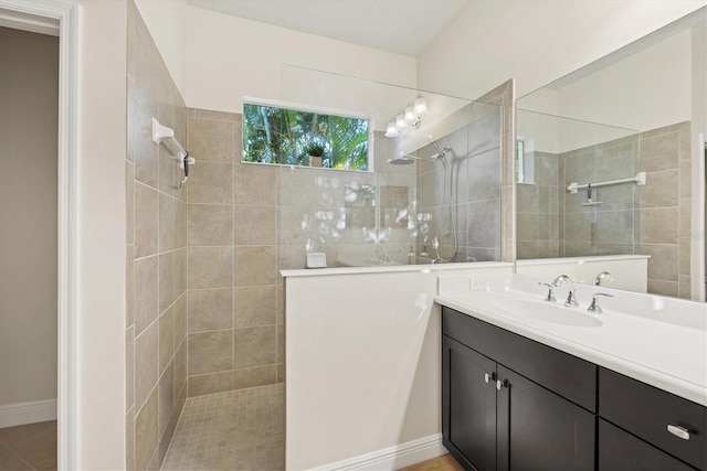 bathroom featuring walk in shower and vanity