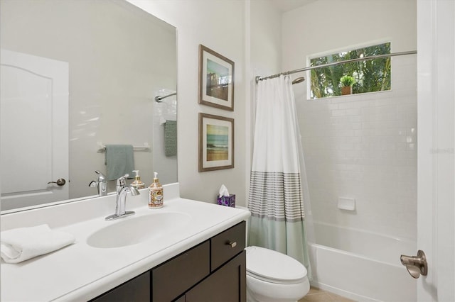 bathroom with shower / bath combo, vanity, and toilet