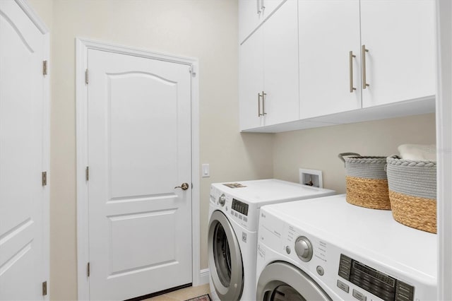 washroom featuring cabinet space and separate washer and dryer