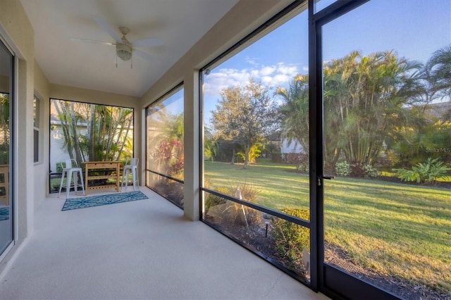 unfurnished sunroom with a ceiling fan