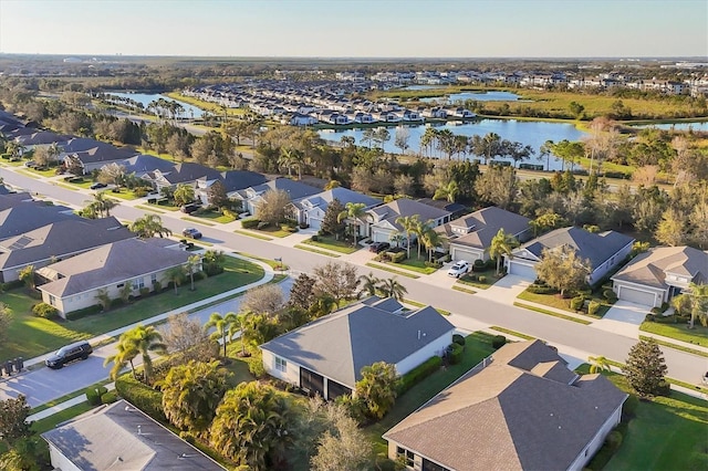 birds eye view of property featuring a water view and a residential view