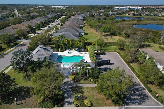 drone / aerial view with a residential view and a water view