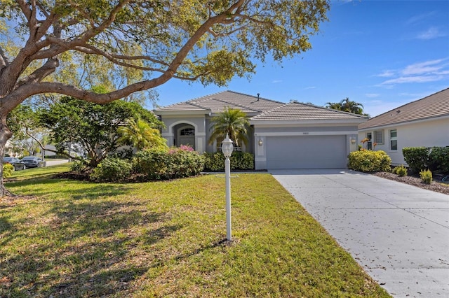 single story home featuring a garage, driveway, a tiled roof, stucco siding, and a front yard