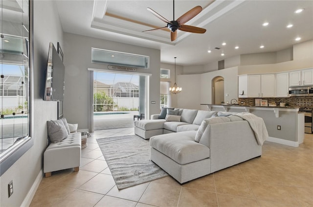 8420 Sailing Loop, Lakewood Ranch, FL 34202 - living area with ceiling fan, recessed lighting, a tray ceiling, light tile patterned floors, and a chandelier
