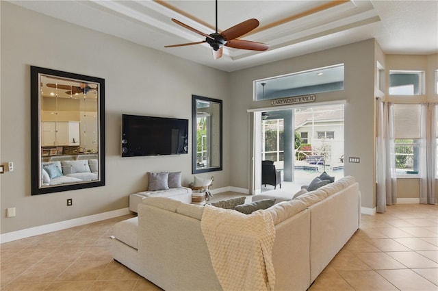 8420 Sailing Loop, Lakewood Ranch, FL 34202 - living room with a tray ceiling, ceiling fan, light tile patterned floors, and baseboards