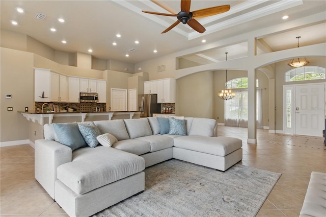 8420 Sailing Loop, Lakewood Ranch, FL 34202 - living room featuring a chandelier, light tile patterned flooring, arched walkways, a high ceiling, and recessed lighting