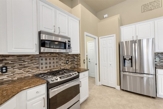 8420 Sailing Loop, Lakewood Ranch, FL 34202 - kitchen with stainless steel appliances, white cabinetry, backsplash, and dark stone counters