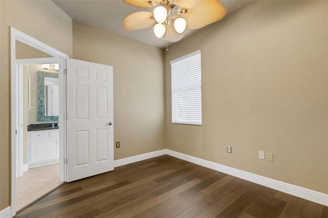 8420 Sailing Loop, Lakewood Ranch, FL 34202 - unfurnished bedroom with wood finished floors, baseboards, connected bathroom, and ceiling fan