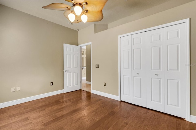 8420 Sailing Loop, Lakewood Ranch, FL 34202 - unfurnished bedroom with wood finished floors, baseboards, a closet, and a ceiling fan