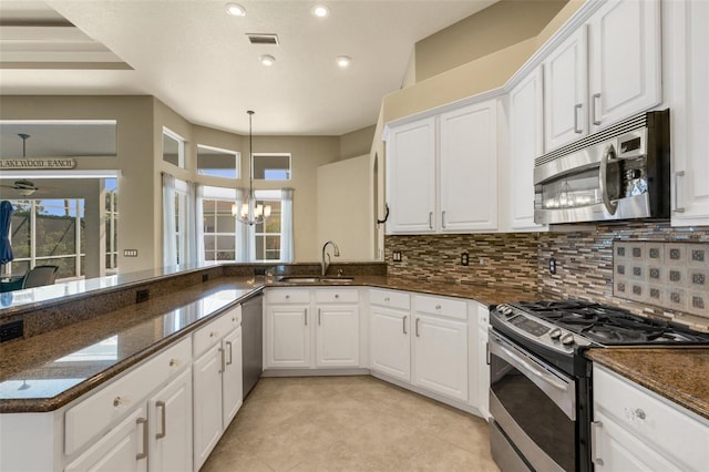 8420 Sailing Loop, Lakewood Ranch, FL 34202 - kitchen with stainless steel appliances, a sink, a chandelier, healthy amount of natural light, and recessed lighting
