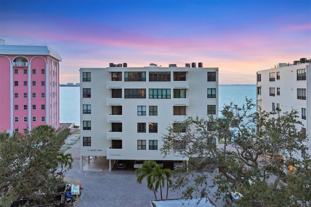 property at dusk with a water view