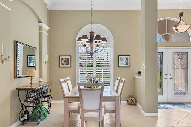 dining area featuring a chandelier, light tile patterned flooring, a high ceiling, baseboards, and ornamental molding