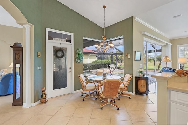 dining space featuring light tile patterned floors, crown molding, baseboards, decorative columns, and an inviting chandelier