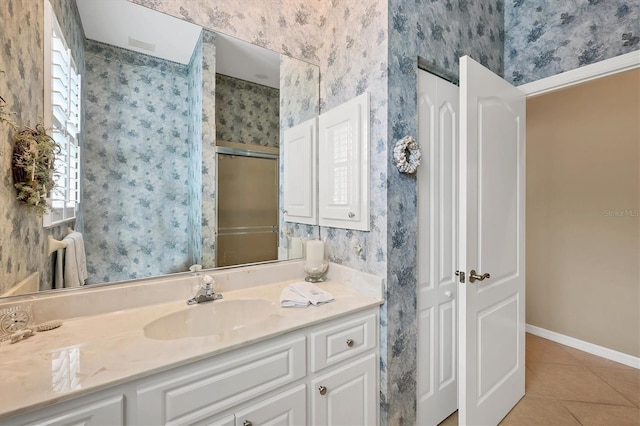 full bath with a shower with shower door, tile patterned floors, a wealth of natural light, and wallpapered walls