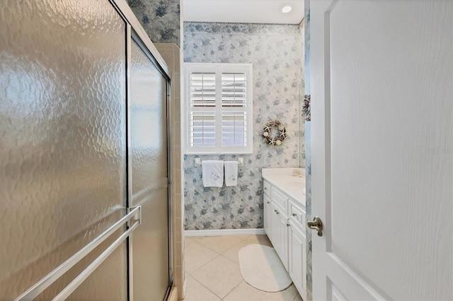 bathroom featuring wallpapered walls, baseboards, a stall shower, and tile patterned floors