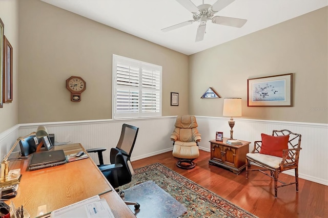 home office with ceiling fan, wood finished floors, and wainscoting