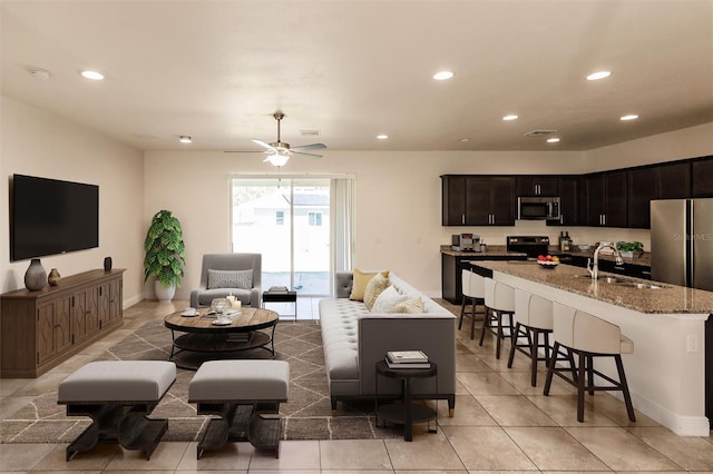 living room featuring ceiling fan, light tile patterned floors, recessed lighting, visible vents, and baseboards