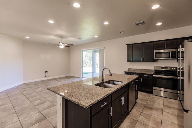 kitchen featuring visible vents, appliances with stainless steel finishes, light stone countertops, a sink, and recessed lighting