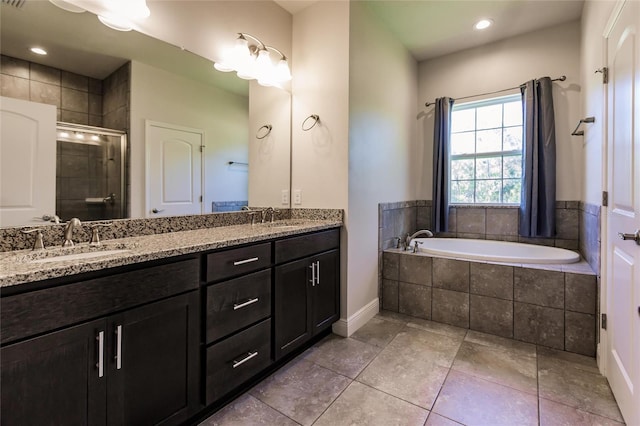 bathroom with a garden tub, double vanity, a sink, and a shower stall