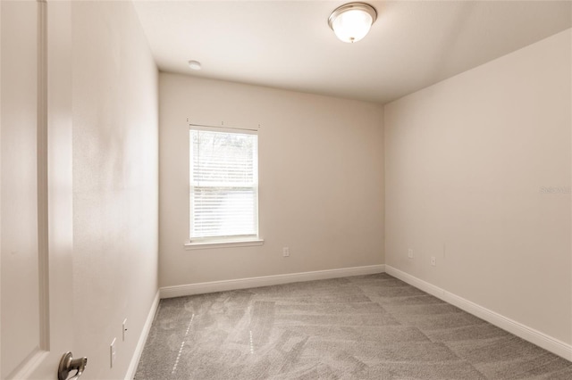 empty room with carpet and baseboards