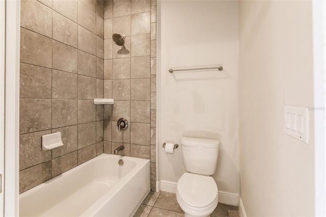 bathroom with baseboards, bathing tub / shower combination, toilet, and tile patterned floors