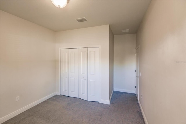 unfurnished bedroom with baseboards, a closet, visible vents, and carpet flooring